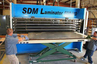 Image of the large 600 ton SDM Laminator panel press.